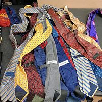 Overview of 15 assorted men's ties spread on table