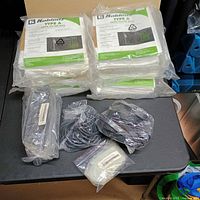 Stacked sealed packs of Koblenz Type A HEPA filter bags with separate bags of belts and filter holders
