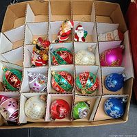 Open ornament box showing 18 ornaments in divided sections