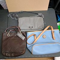 All three handbags laid out for full view