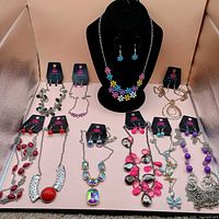 Overview of all ten Paparazzi necklace and earring sets displayed