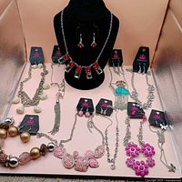 Group overhead view of all ten necklace and earring sets laid out with Paparazzi tags visible