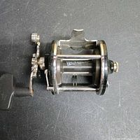 Side view of Penn reel showing spool, star drag, handle and frame