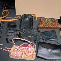 Group shot of all seven purses and coin purse displayed