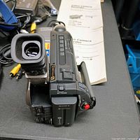Top view of Sony Handycam camcorder showing controls, viewfinder and attached AV cords