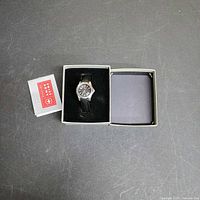 Watch in open presentation box with booklet