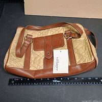 Full view of Villager quilted handbag with ruler for scale