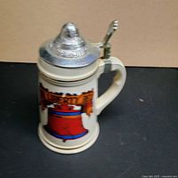 Stein side view showing graphic and closed lid