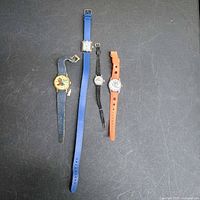 All four watches laid out side by side