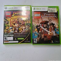 Front covers of LEGO Indiana Jones and LEGO Pirates Of The Caribbean Xbox 360 games