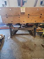 Front view of Black & Decker Workmate showing wood top and branding on metal frame