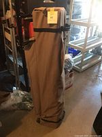 Canopy packed in brown rolling bag