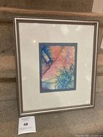 Front view of framed artwork showing image, mat and frame