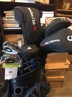 Bag showing Founders Club headcovers and irons