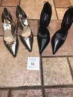 Both pairs of shoes side by side on tile floor