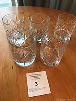 Five Dewar’s Celtic knot tumblers on table