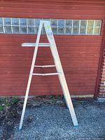Full view of aluminum step ladder standing folded