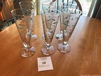 Six Libbey Atomic Fish pilsner glasses grouped on table