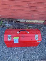 Closed red metal toolbox front view