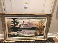 Full view of framed painting leaning against wall