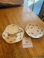 Cup on dessert plate, saucer beside, showing pattern and set components