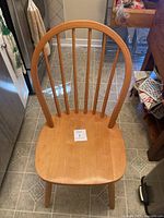 Front view of chair showing seat, spindle back and legs