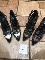 Both pairs of Tory Burch stiletto pumps side by side