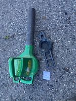 Blower body with accessory on asphalt