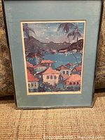 Overall view of framed signed painting depicting coastal village