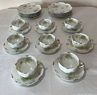 All pieces arranged: cups on saucers, stacks of salad plates