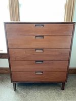 Front view of five-drawer wooden dresser with inset pulls