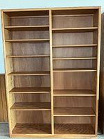 Front view showing entire oak bookcase with empty adjustable shelves
