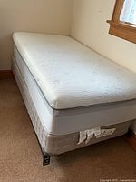 Twin mattress on foundation and metal frame