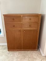 Front view of cabinet with drawers closed and doors shut