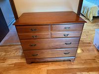 Front view showing all five drawers and detached handle area