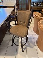Front view of barstool showing frame, arms, seat and back cushions