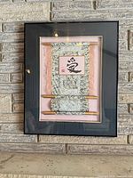 Framed mixed media scroll artwork full view on wall