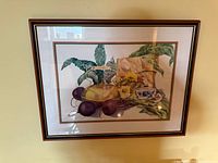 Full view of framed Oswald still life print on wall