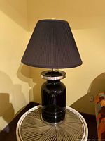 Full view of lamp on side table showing shade and base