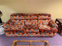 Front view of upholstered sofa showing full design and pattern