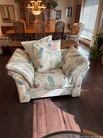 Front view of oversized patterned armchair with cushions