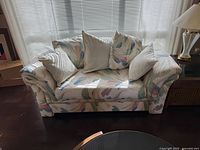 Front view of Klaussner loveseat with pillows