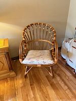 Front view of bamboo rattan armchair showing overall design and cushion