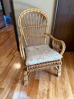 Front angled view of bamboo rattan armchair showing frame and cushion