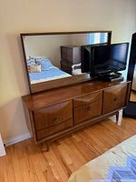 Front view of walnut dresser with mirror and TV for scale