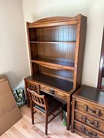 Front view of desk with hutch and chair showing overall design and finish