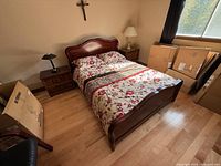 Full view of queen wooden bed frame with bedding in room