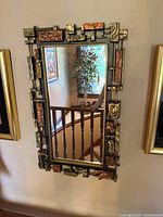 Front view of Syroco mirror hanging on wall