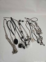 Full group of necklaces spread out showing variety of chains and pendants