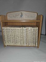 Full view of 23 books in wooden shelf